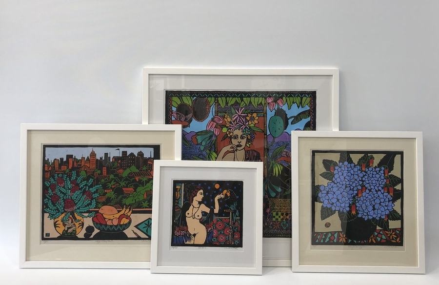 Group of four colourful framed prints