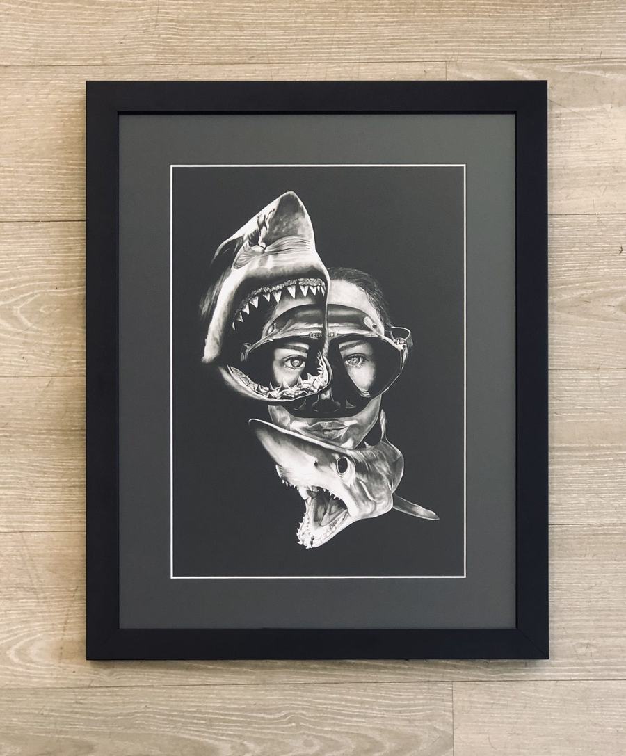 Framed black and white diver with sharks artwork