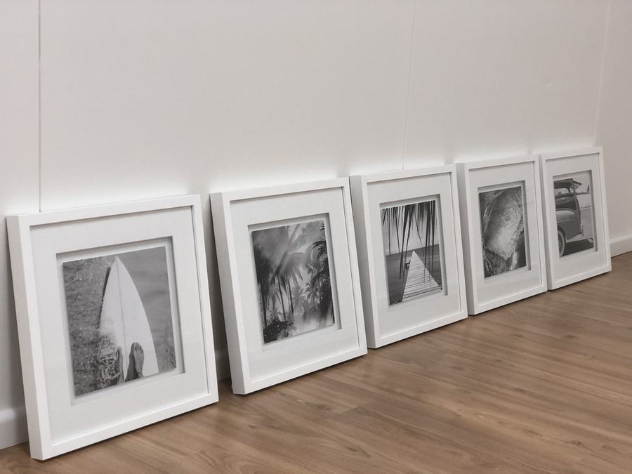 Row of five framed surf and beach prints